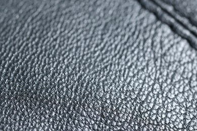 Photo of Black leather with seam as background, closeup