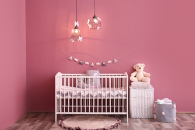 Photo of Modern baby room interior with crib