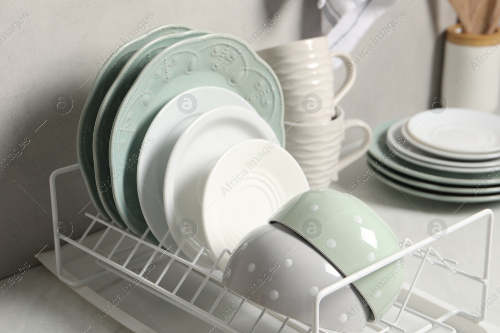 Photo of Many different clean dishware and cups on white table indoors