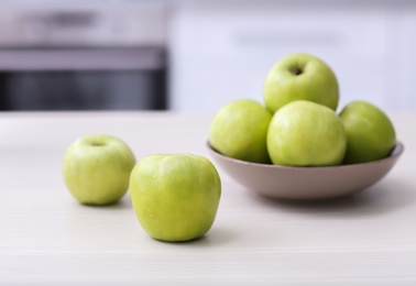 Photo of Plate with ripe green apples on table