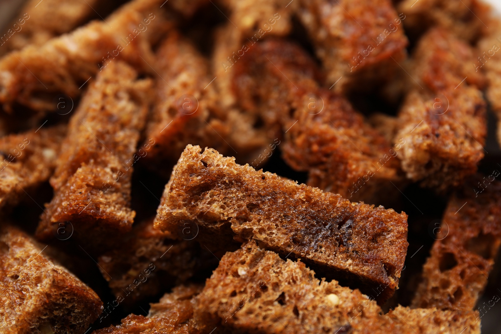 Photo of Delicious crispy rusks as background, closeup view