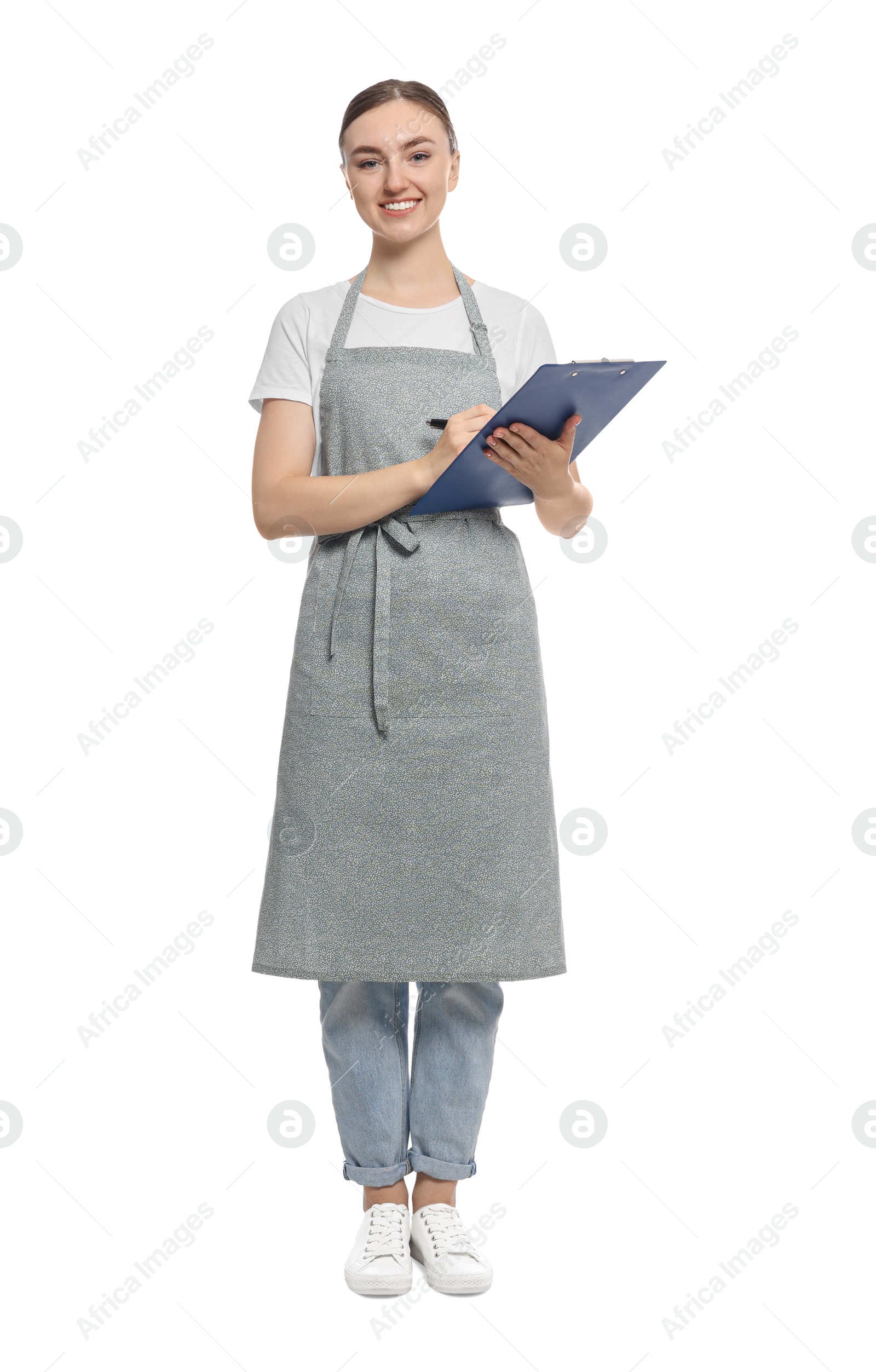 Photo of Beautiful young woman in clean apron with clipboard on white background