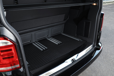 Photo of Modern car with open empty trunk outdoors