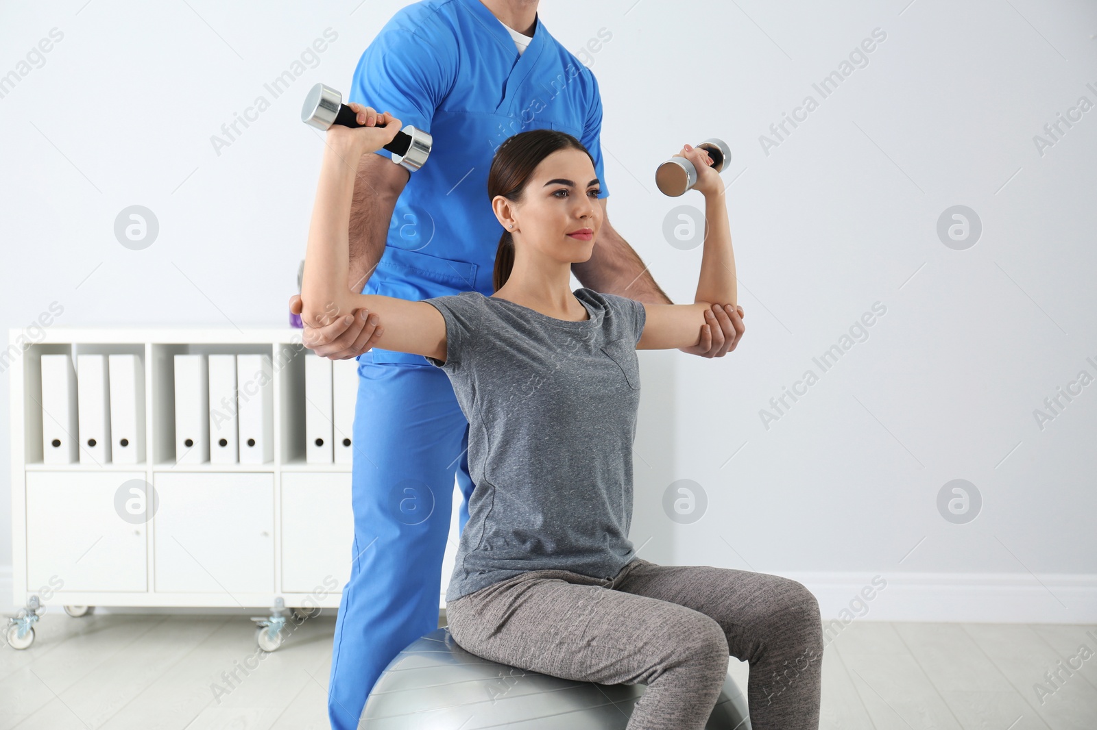 Photo of Doctor working with patient in hospital. Rehabilitation exercises