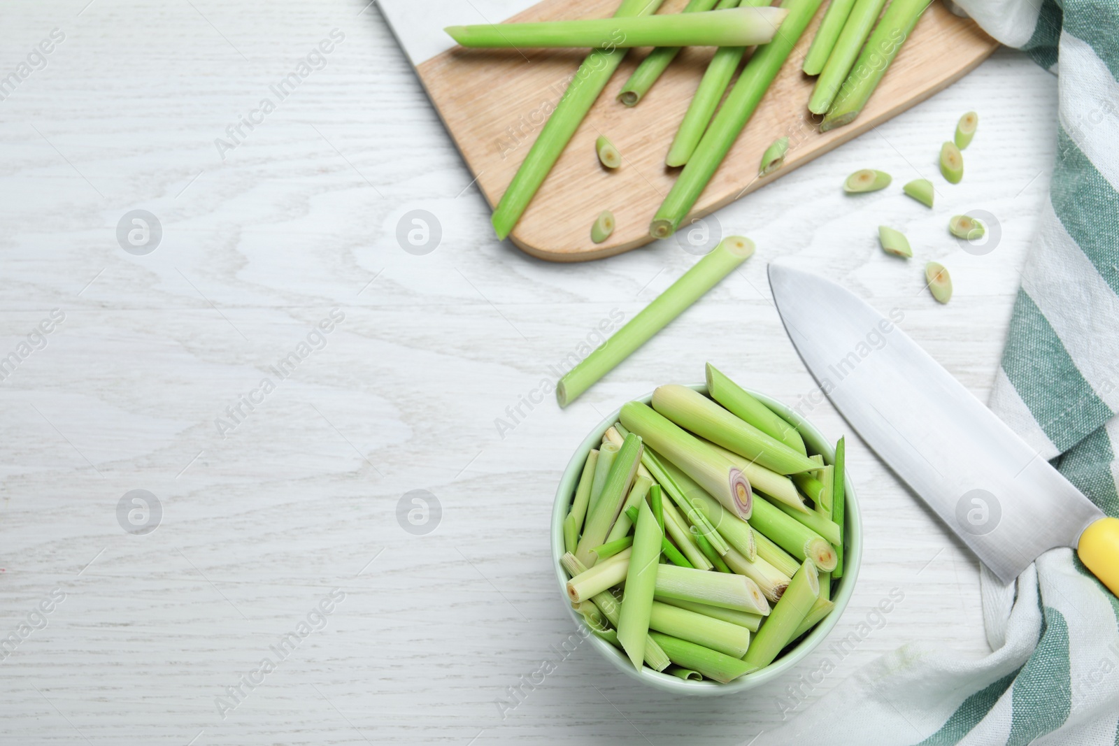 Photo of Flat lay composition with fresh lemongrass stalks on white wooden table. Space for text