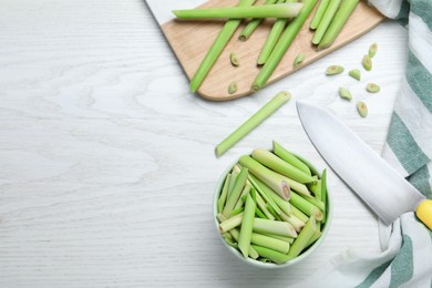 Flat lay composition with fresh lemongrass stalks on white wooden table. Space for text