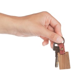 Woman holding key with wooden keychain on white background, closeup