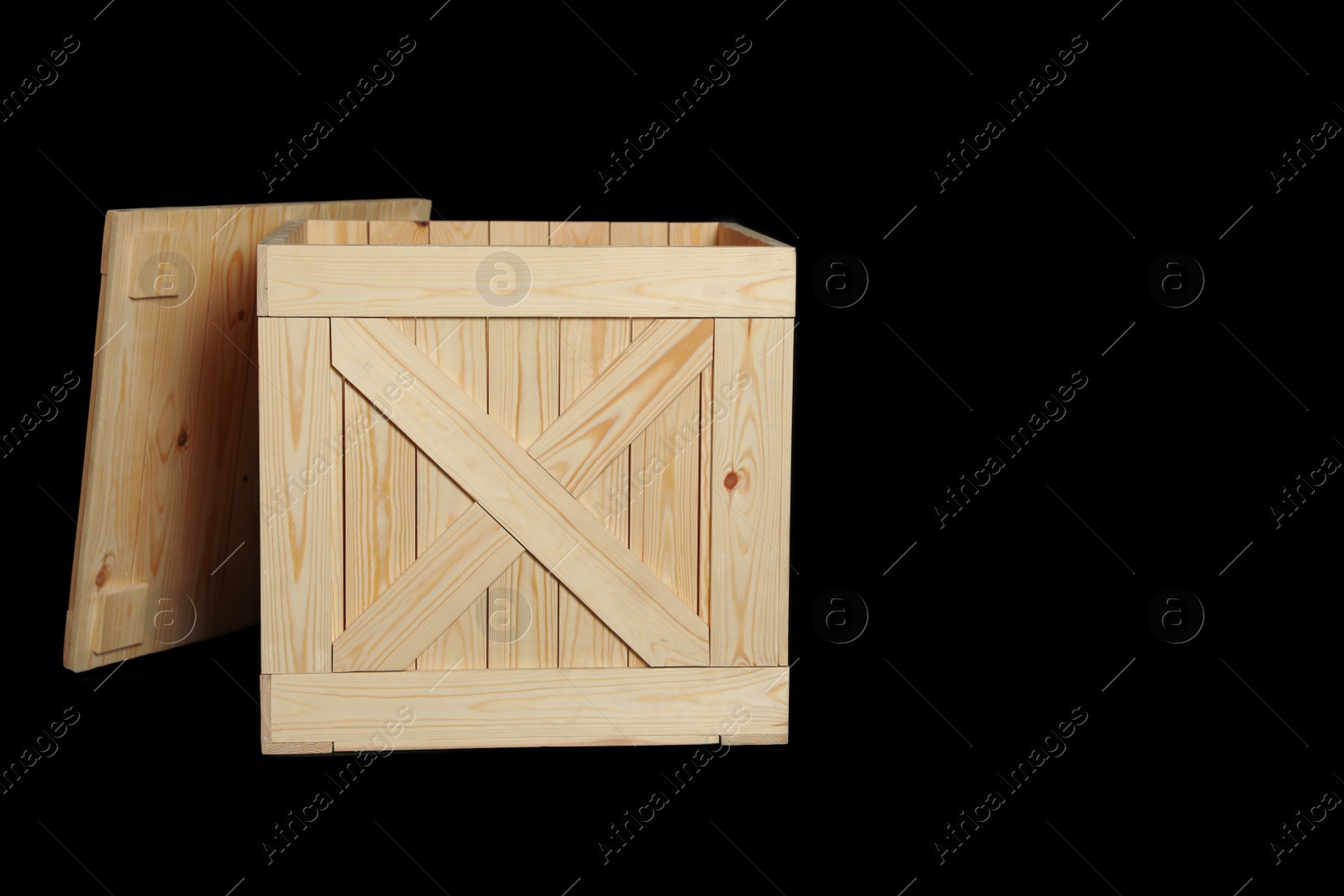 Photo of Wooden crate on black background. Space for text