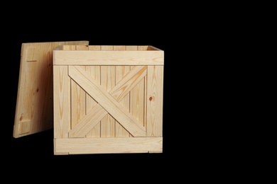 Photo of Wooden crate on black background. Space for text