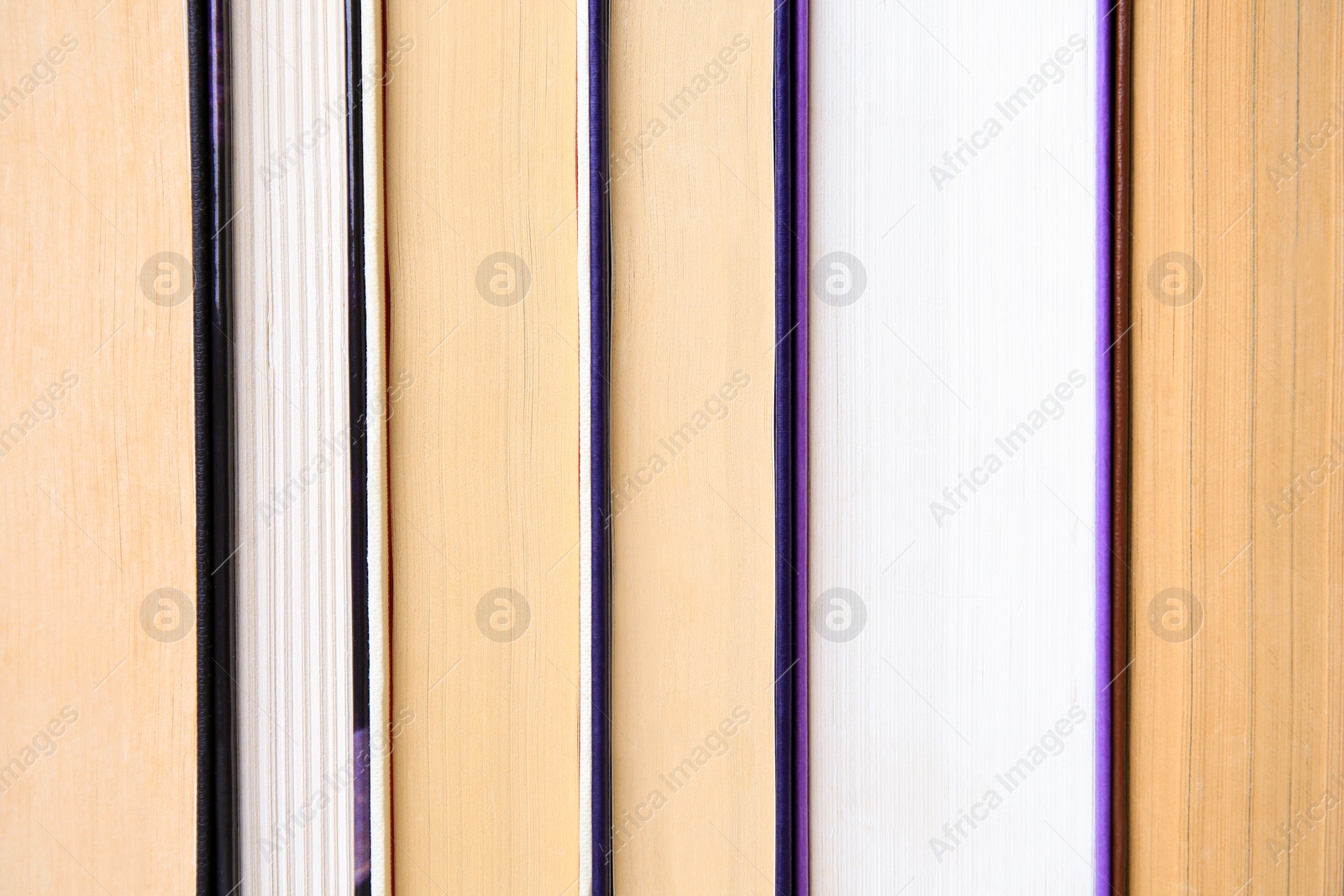 Photo of Many different books as background, closeup view