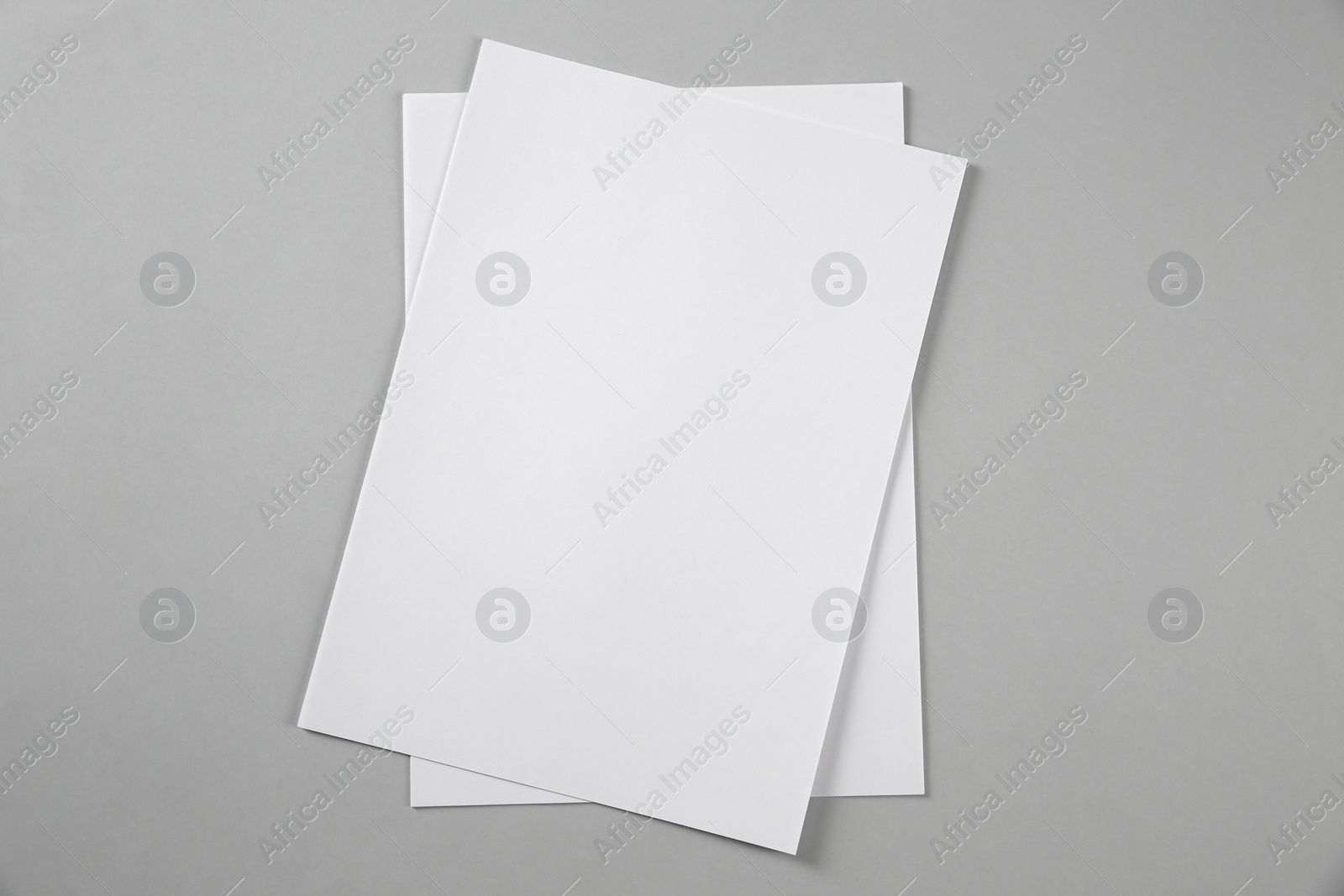 Photo of Blank brochures on grey background, top view. Mockup for design