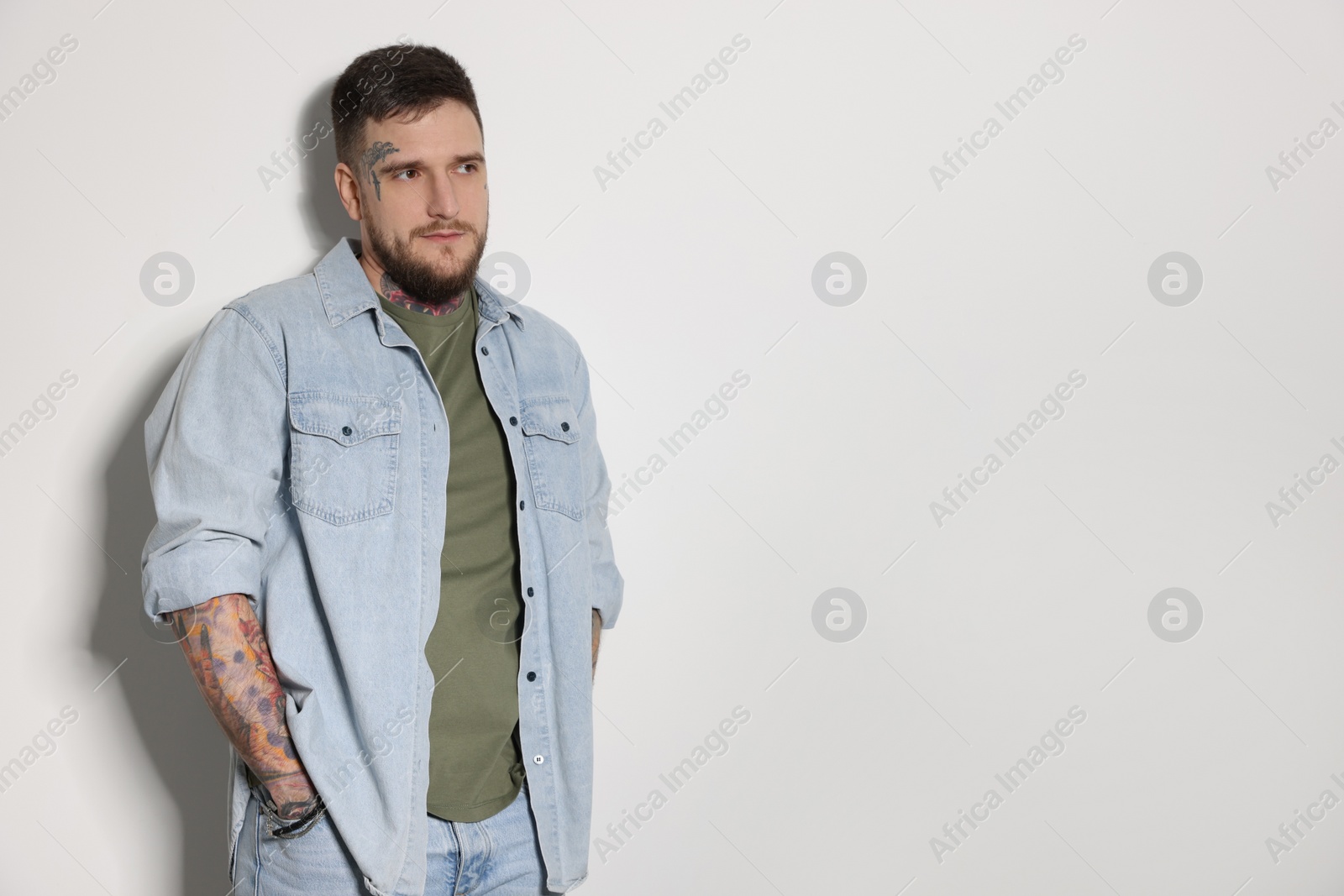 Photo of Handsome hipster man on light grey background. Space for text