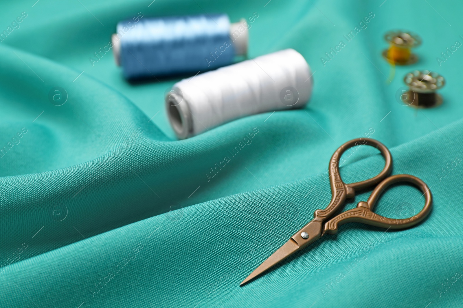 Photo of Composition with threads and sewing accessories on fabric