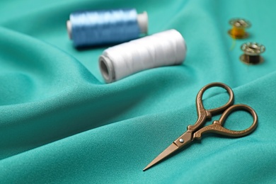 Photo of Composition with threads and sewing accessories on fabric