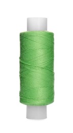 Photo of Spool of light green sewing thread isolated on white
