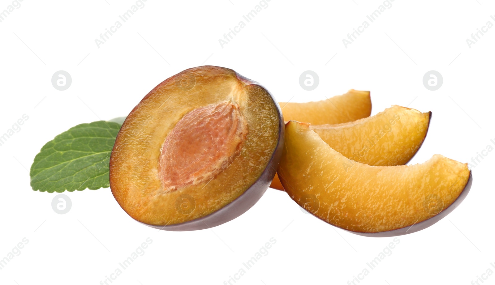 Photo of Cut ripe plums with green leaf isolated on white