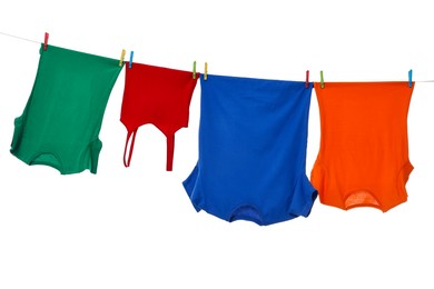 Photo of Different clothes drying on laundry line against white background