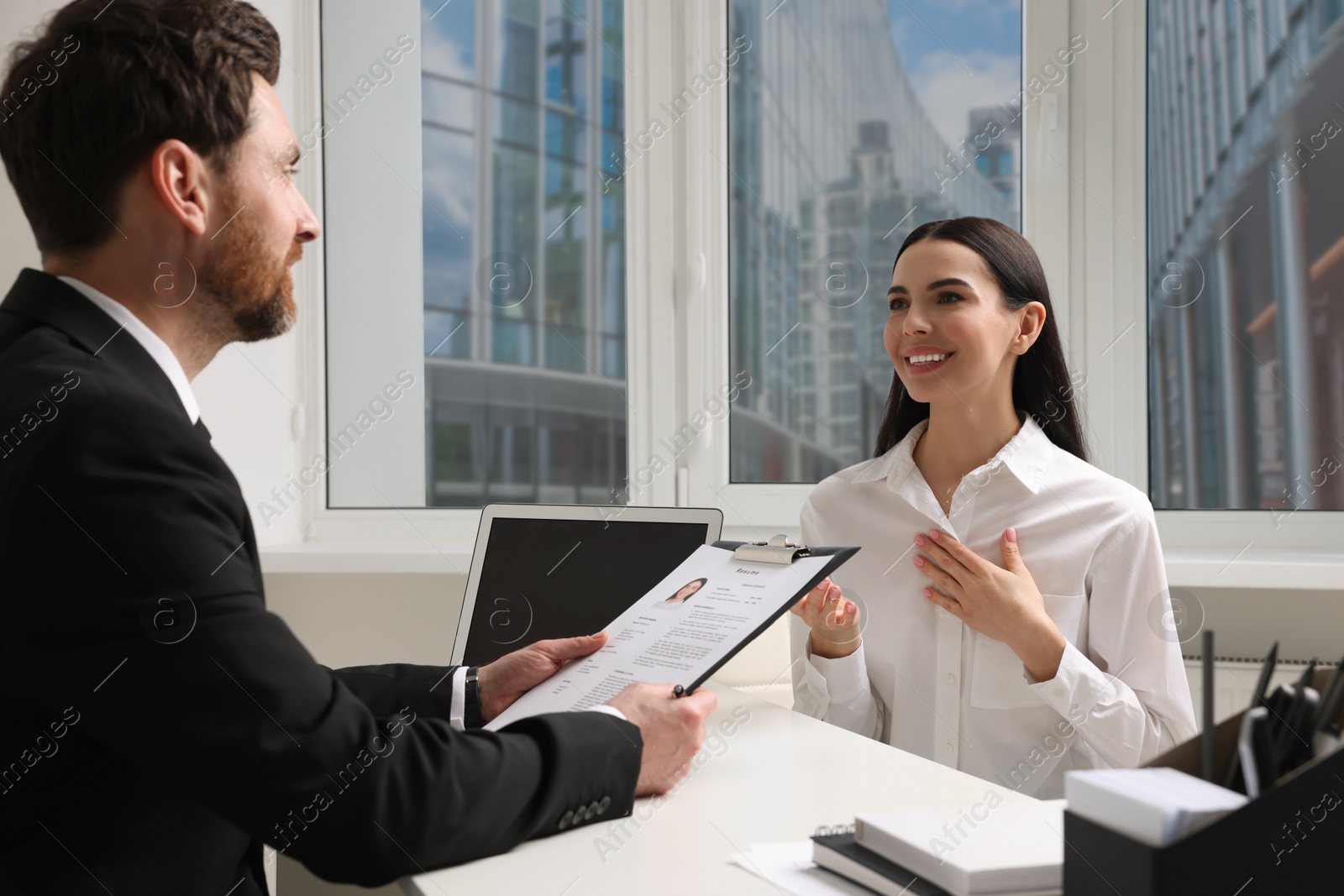 Photo of Human resources manager conducting job interview with applicant in office