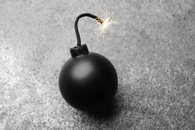 Old fashioned fuse bomb on grey table, above view