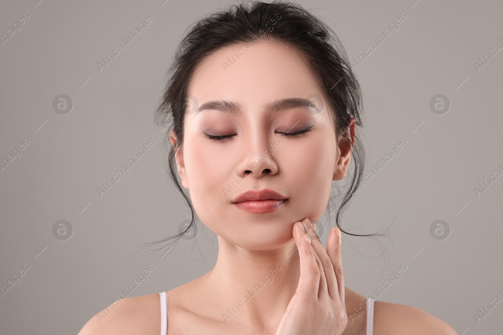 Photo of Portrait of beautiful woman on grey background