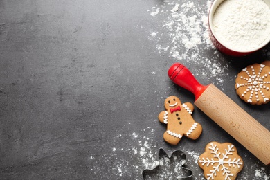 Flat lay composition with tasty homemade Christmas cookies on dark grey table, space for text