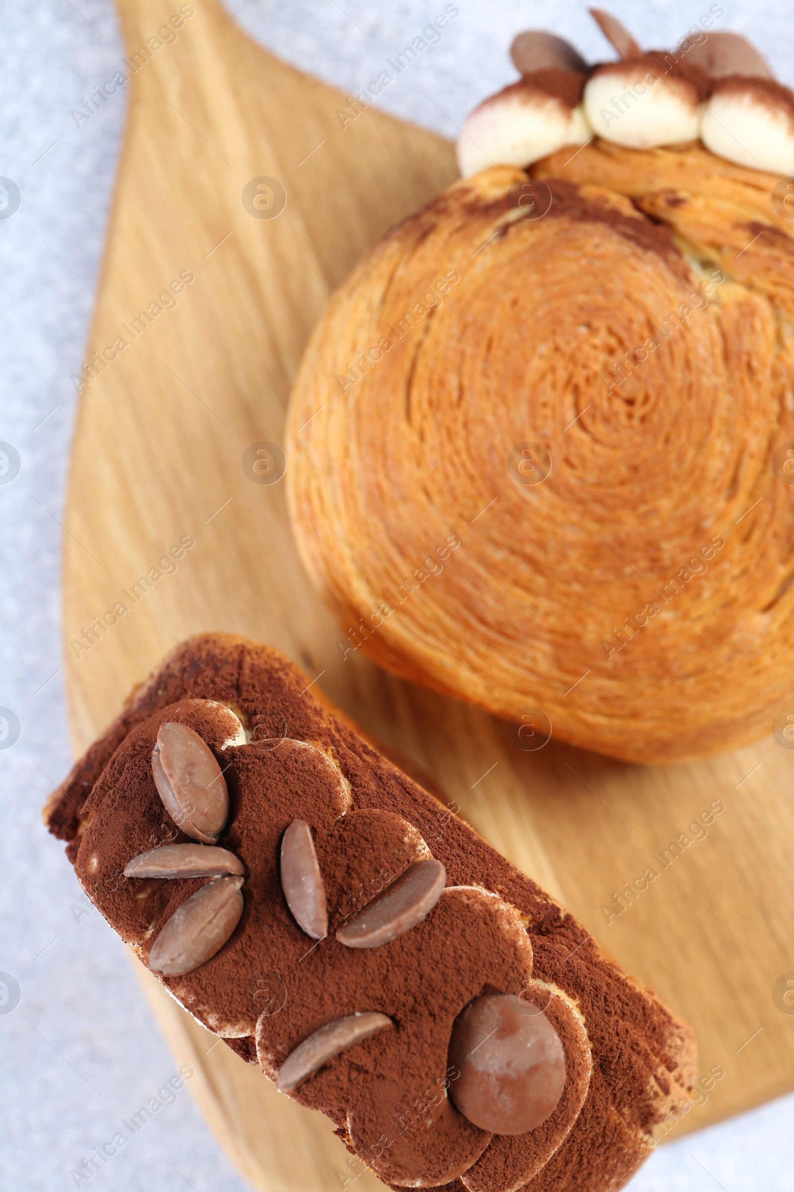 Photo of Supreme croissants with chocolate chips and cream on grey table, above view. Tasty puff pastry