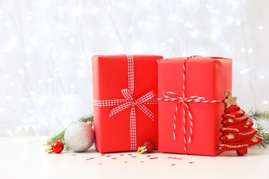 Photo of Christmas gifts on table against blurred background