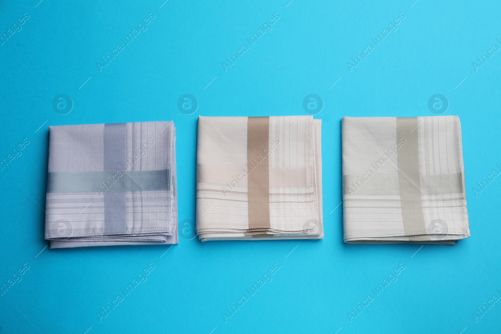 Photo of Stylish handkerchiefs on light blue background, flat lay