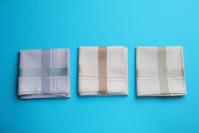 Photo of Stylish handkerchiefs on light blue background, flat lay