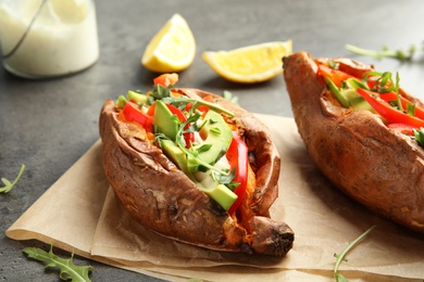 Stuffed sweet potatoes served on parchment, closeup