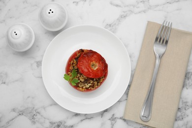 Photo of Delicious stuffed tomato with minced beef, bulgur and mushrooms on white marble table, flat lay