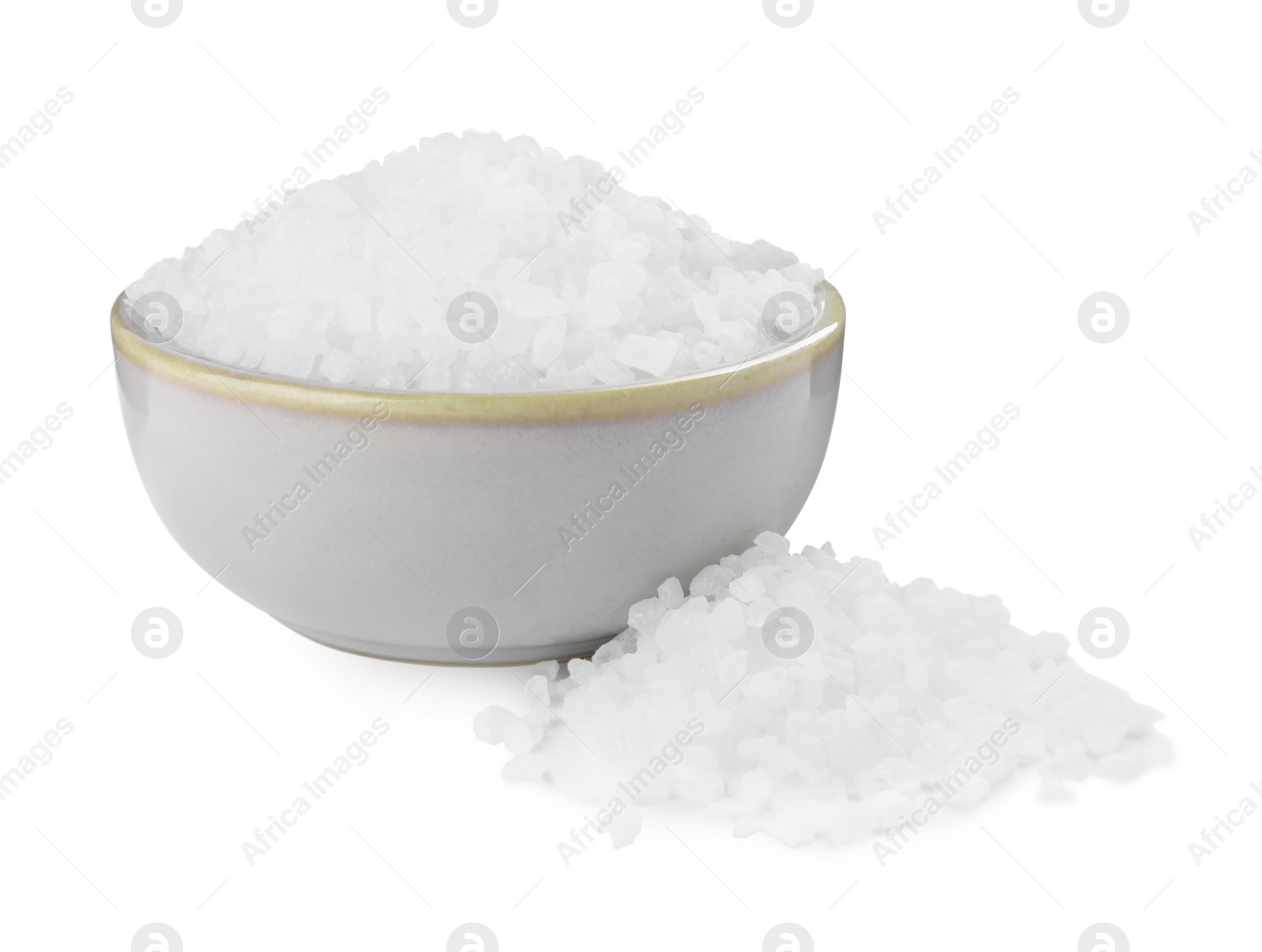Photo of Ceramic bowl and heap of natural sea salt isolated on white