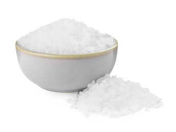 Photo of Ceramic bowl and heap of natural sea salt isolated on white