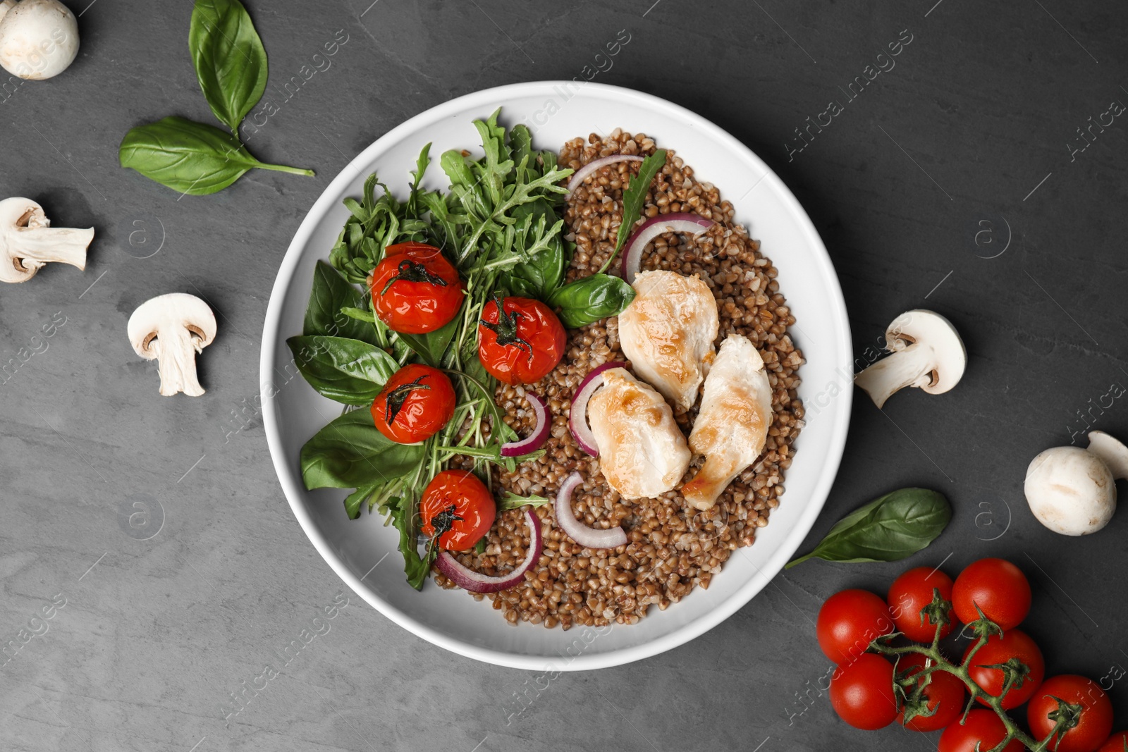 Photo of Flat lay composition with tasty buckwheat porridge on grey table