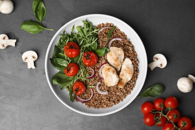 Flat lay composition with tasty buckwheat porridge on grey table