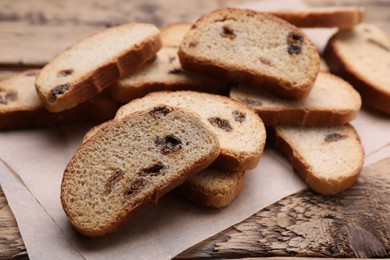 Photo of Sweet hard chuck crackers with raisins on wooden table, closeup