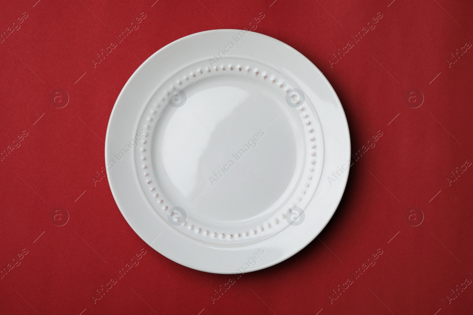 Photo of Clean empty plate on color background, top view