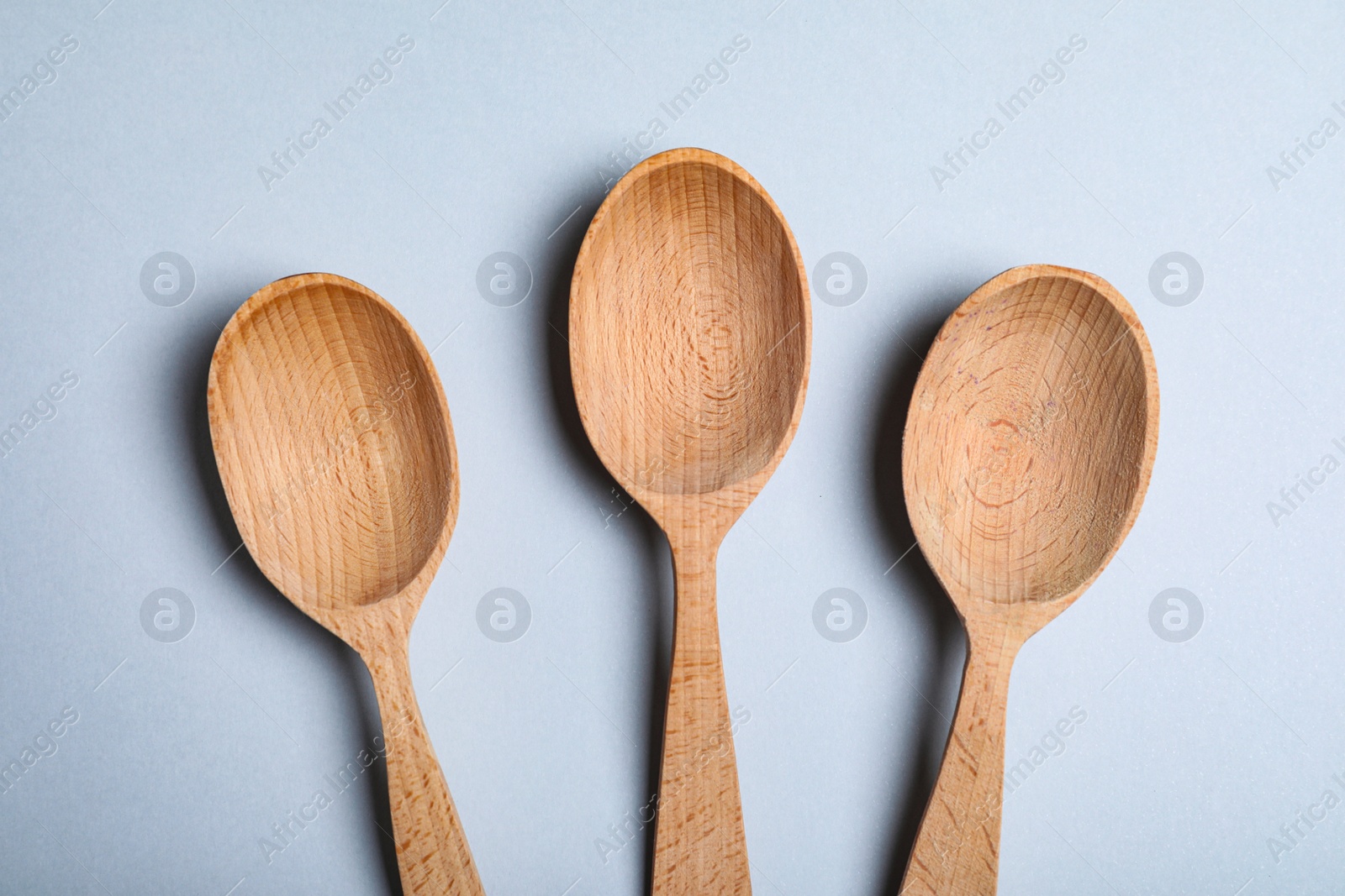 Photo of New wooden spoons on white background, top view