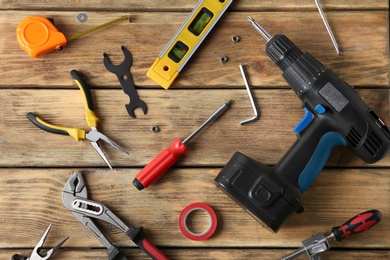 Photo of Set of repair tools on wooden background, flat lay