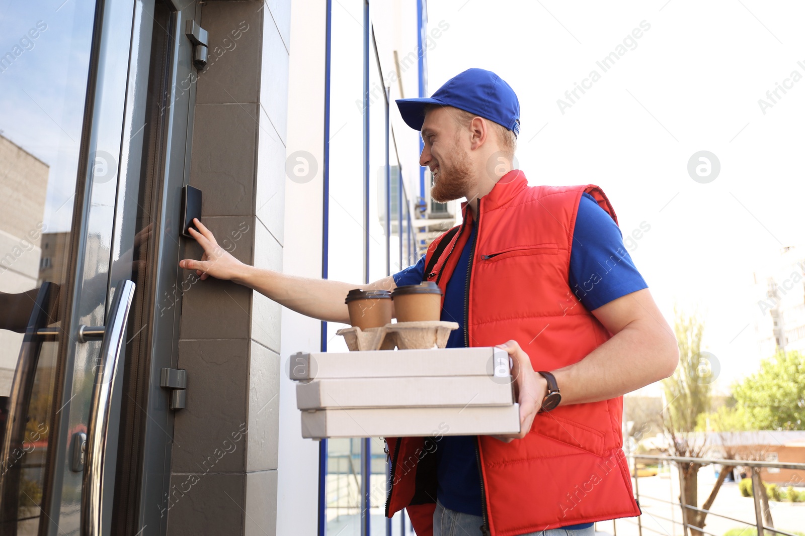 Photo of Portrait of courier with order at door. Food delivery service