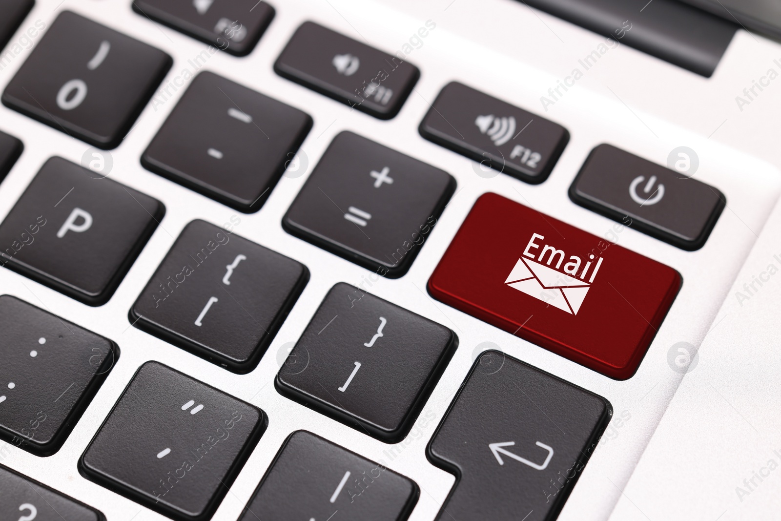 Image of Red button with word Email and illustration of envelope on laptop keyboard, closeup