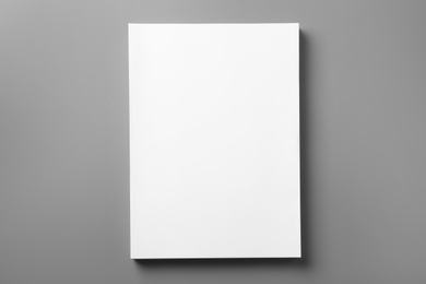Photo of Stack of blank paper sheets for brochure on grey background, top view. Mock up