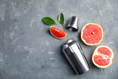 Photo of Flat lay composition with grapefruits and space for text on grey background