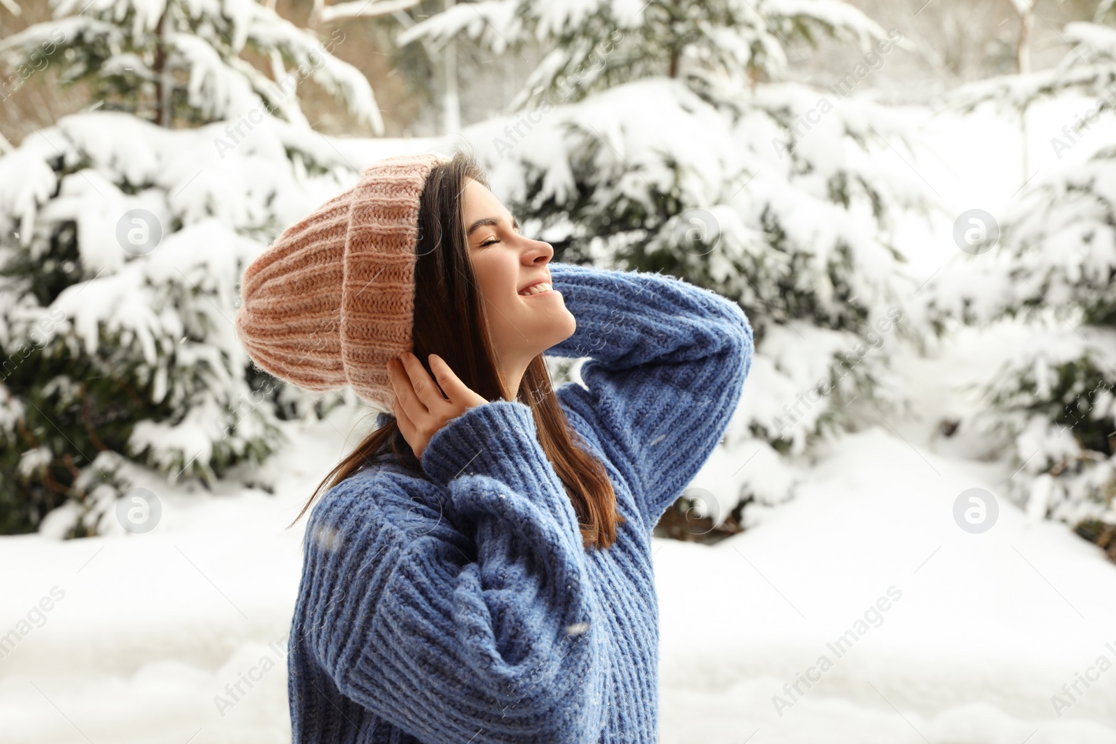 Photo of Pretty woman in warm sweater outdoors on winter day