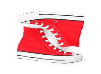 Photo of Pair of new red stylish plimsolls on white background, top view
