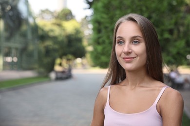 Photo of Portrait of beautiful young woman on city street, space for text