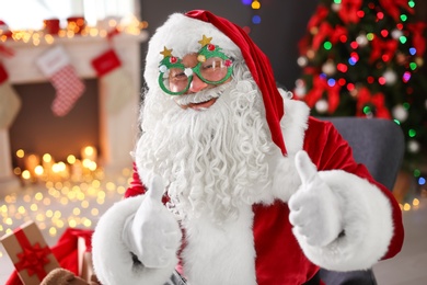 Photo of Authentic Santa Claus with funny glasses indoors