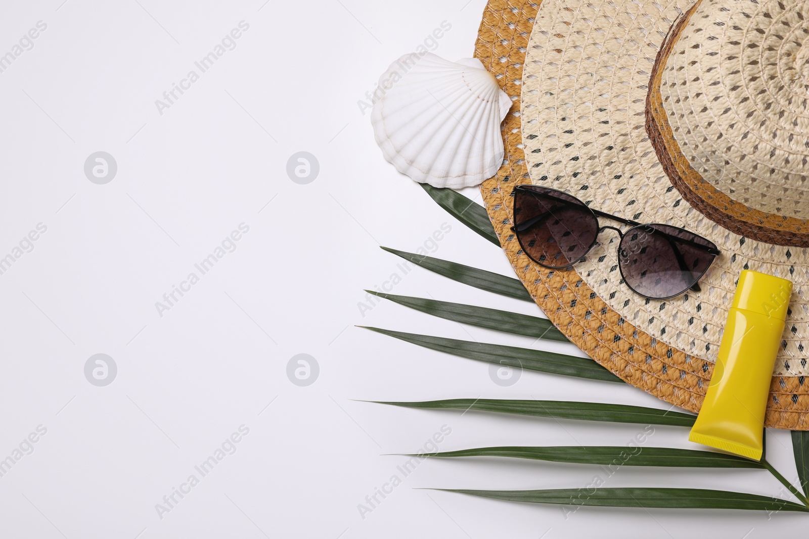 Photo of Flat lay composition with sunscreen and beach accessories on white background. Space for text