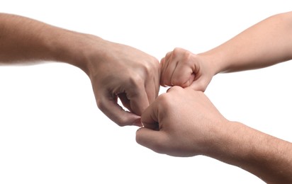 People holding fists together on white background, closeup