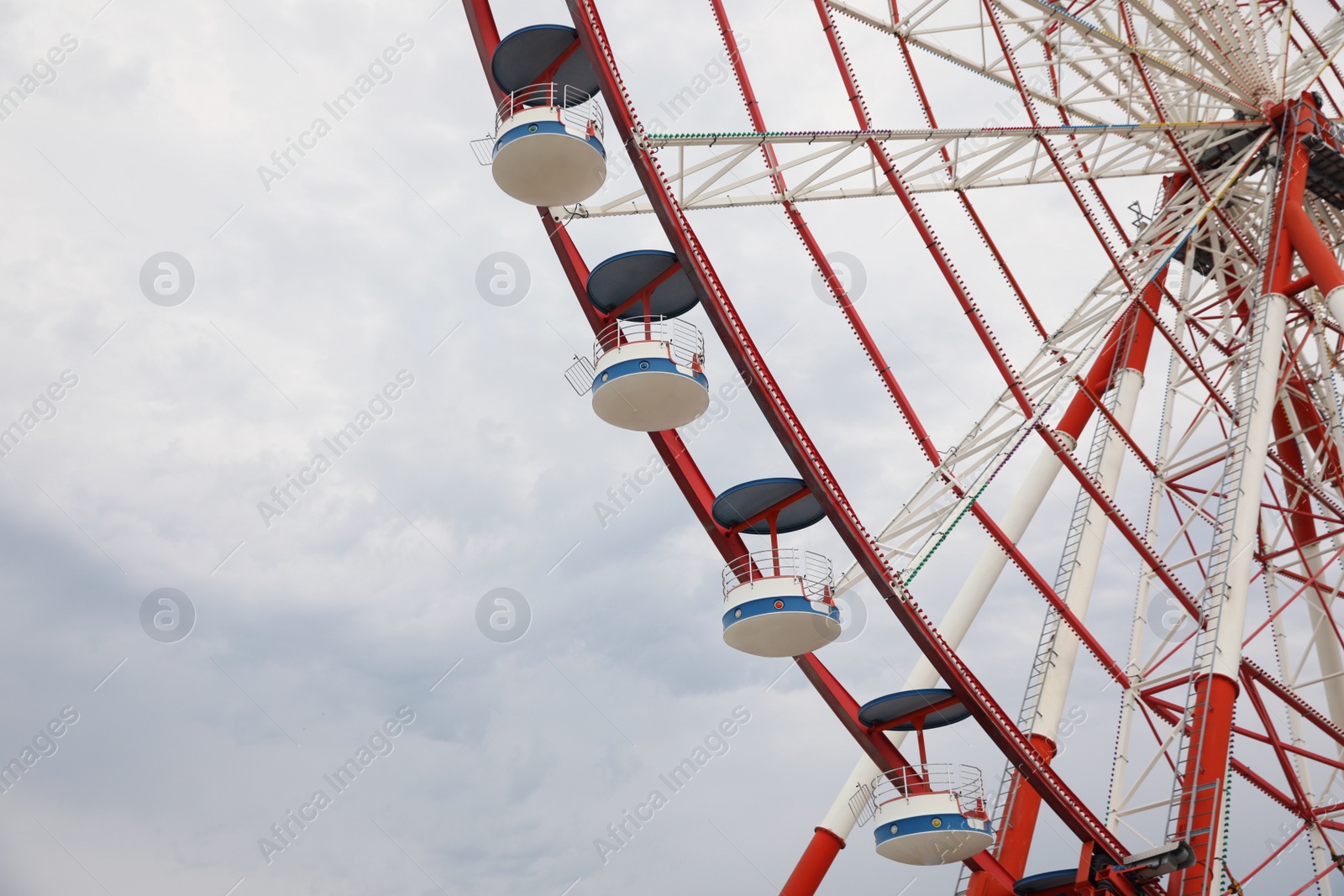 Photo of Beautiful large Ferris wheel outdoors, low angle view. Space for text